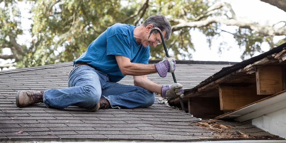 Man repairing the roof of a house